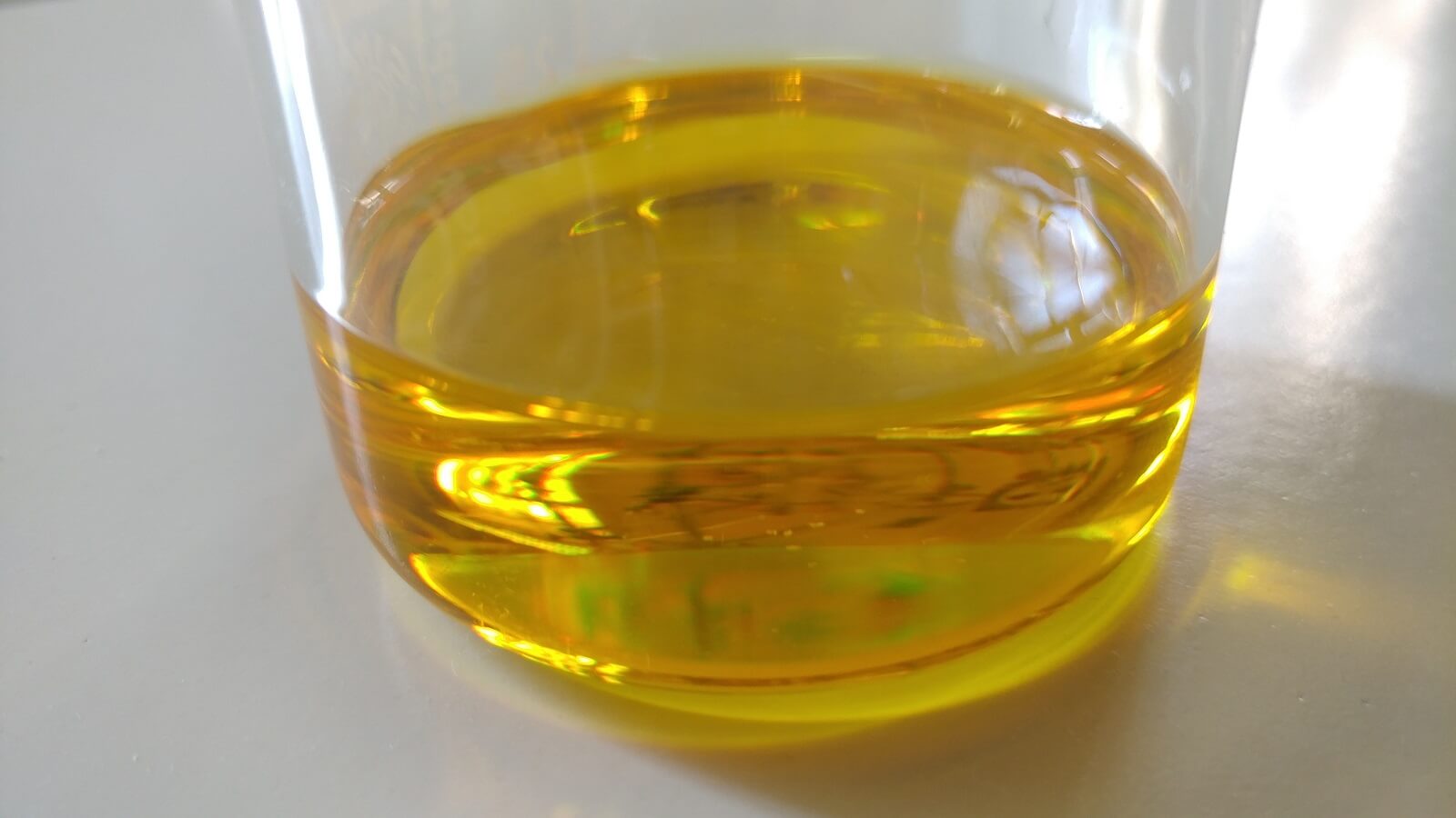 Cinnamaldehyde liquid in a glass container.