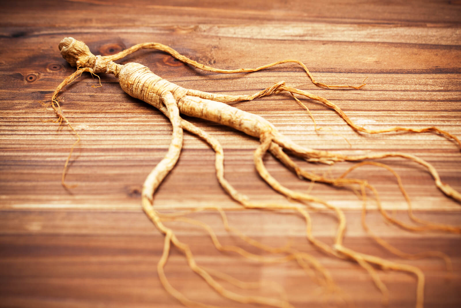 Ginseng root on a wooden surface.