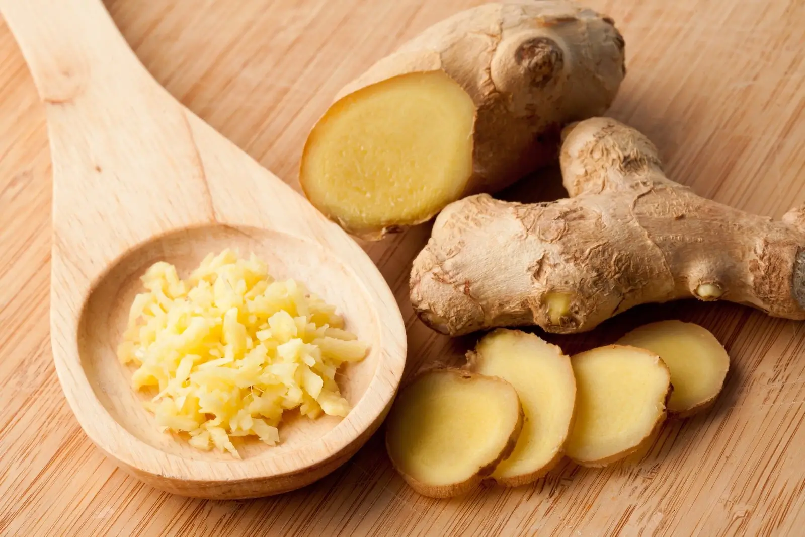 Ginger in various forms, chopped, root, wooden spoon. Ginger root for cooking and fermenting.