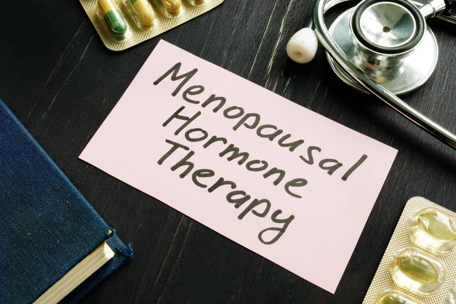 Menopausal hormone therapy MHT inscription and pills with stethoscope.
