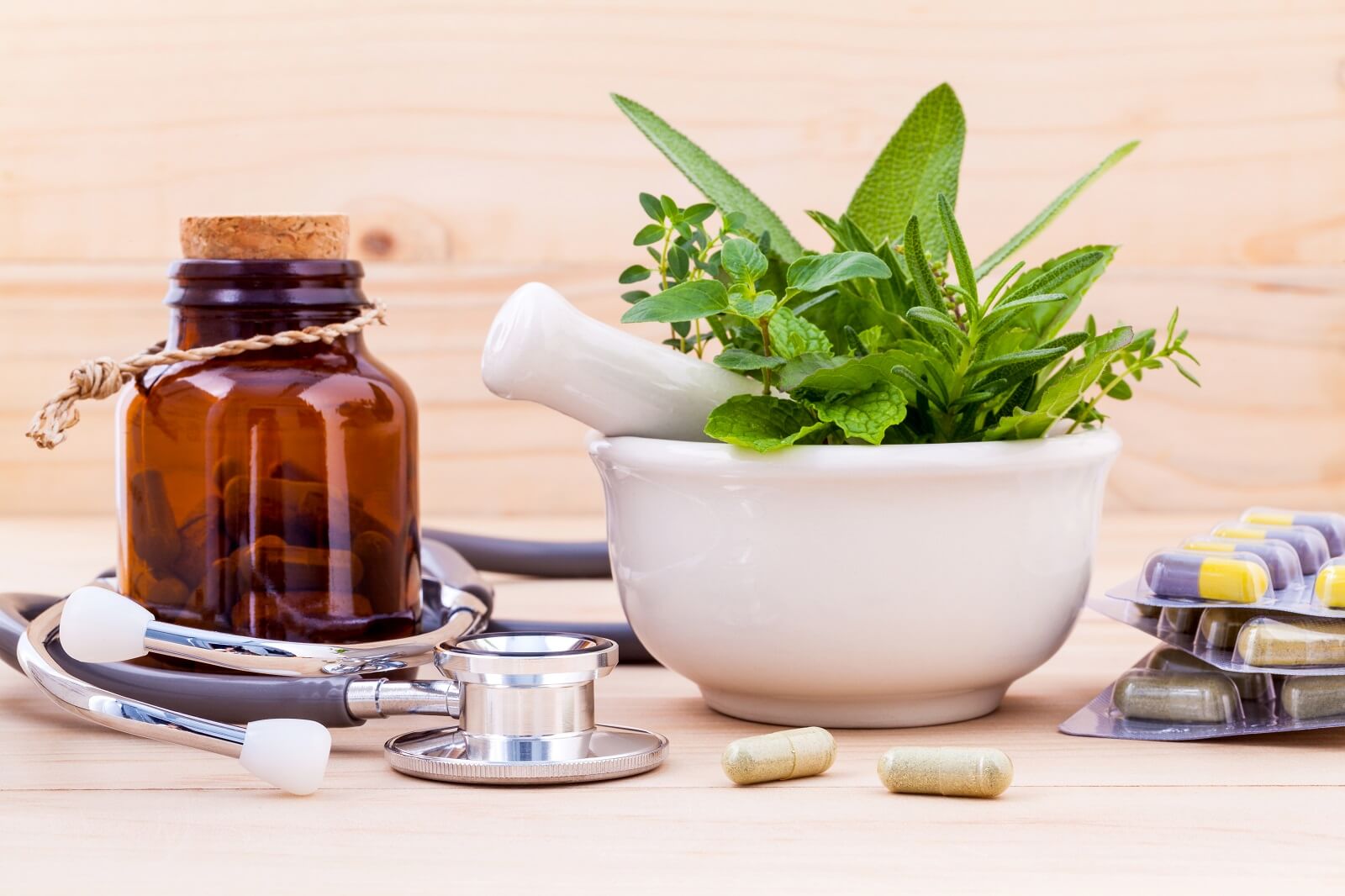 A picture of herbs, mortar and pestle, and stethoscope.