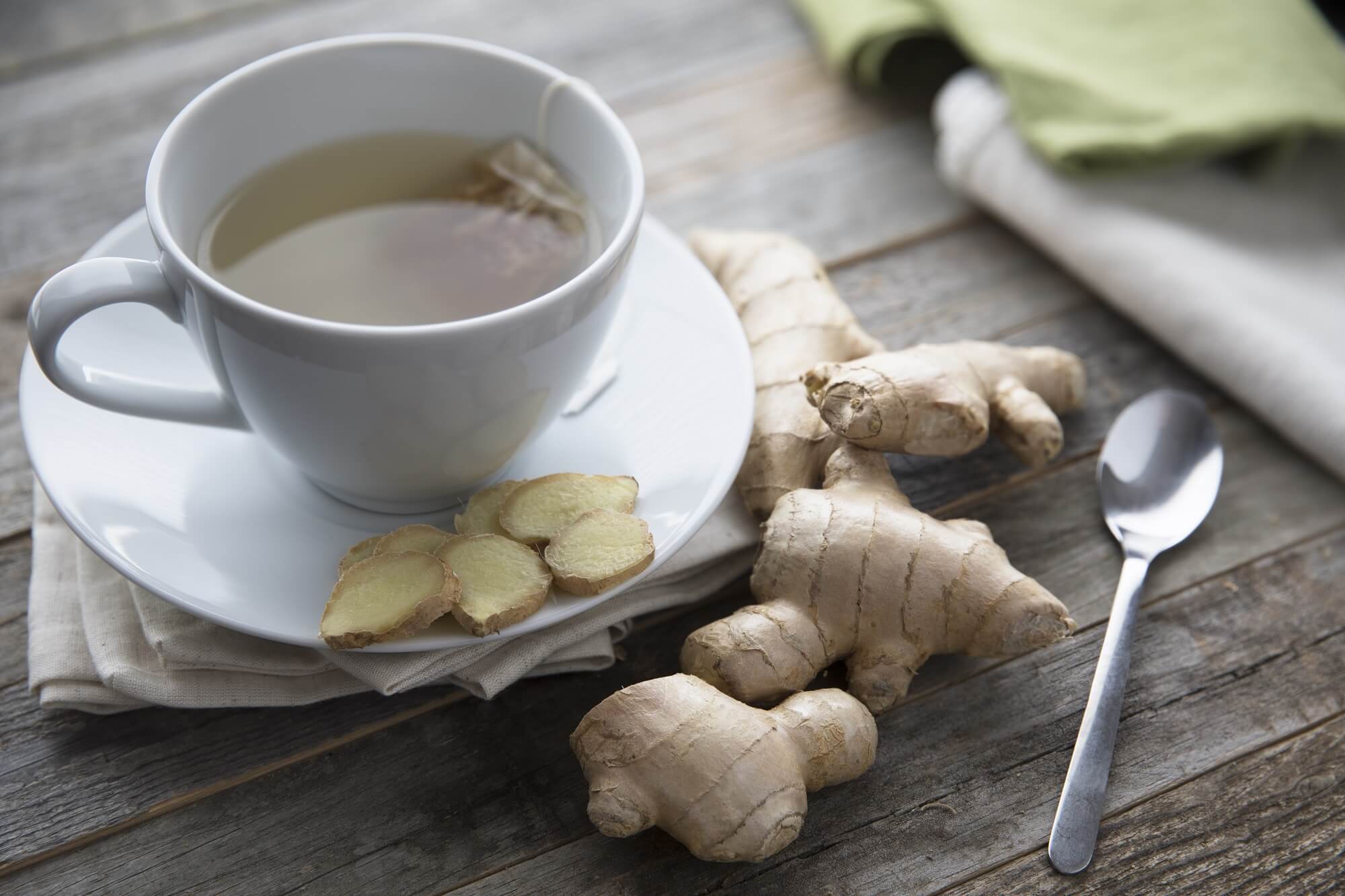 Ginger tea in cup with ginger root