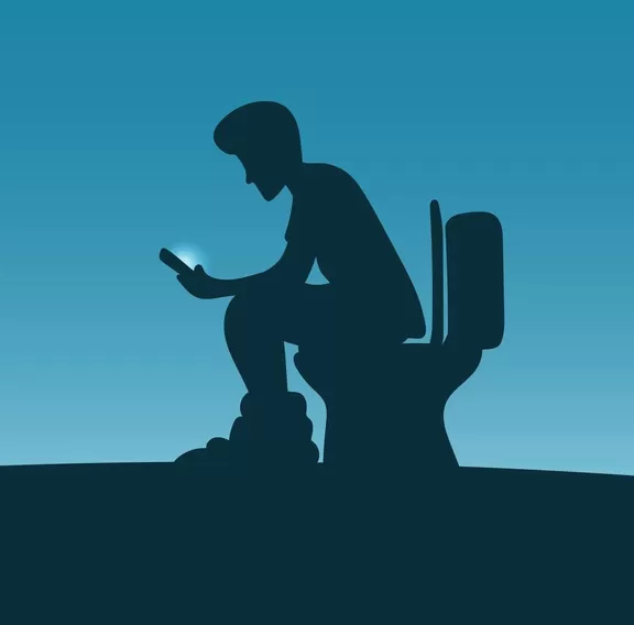 man sitting on toilet bowl and using smartphone for long time in blue gradient shade. Health concept.