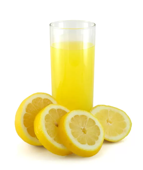 Glass of lemon juice with sliced lemon